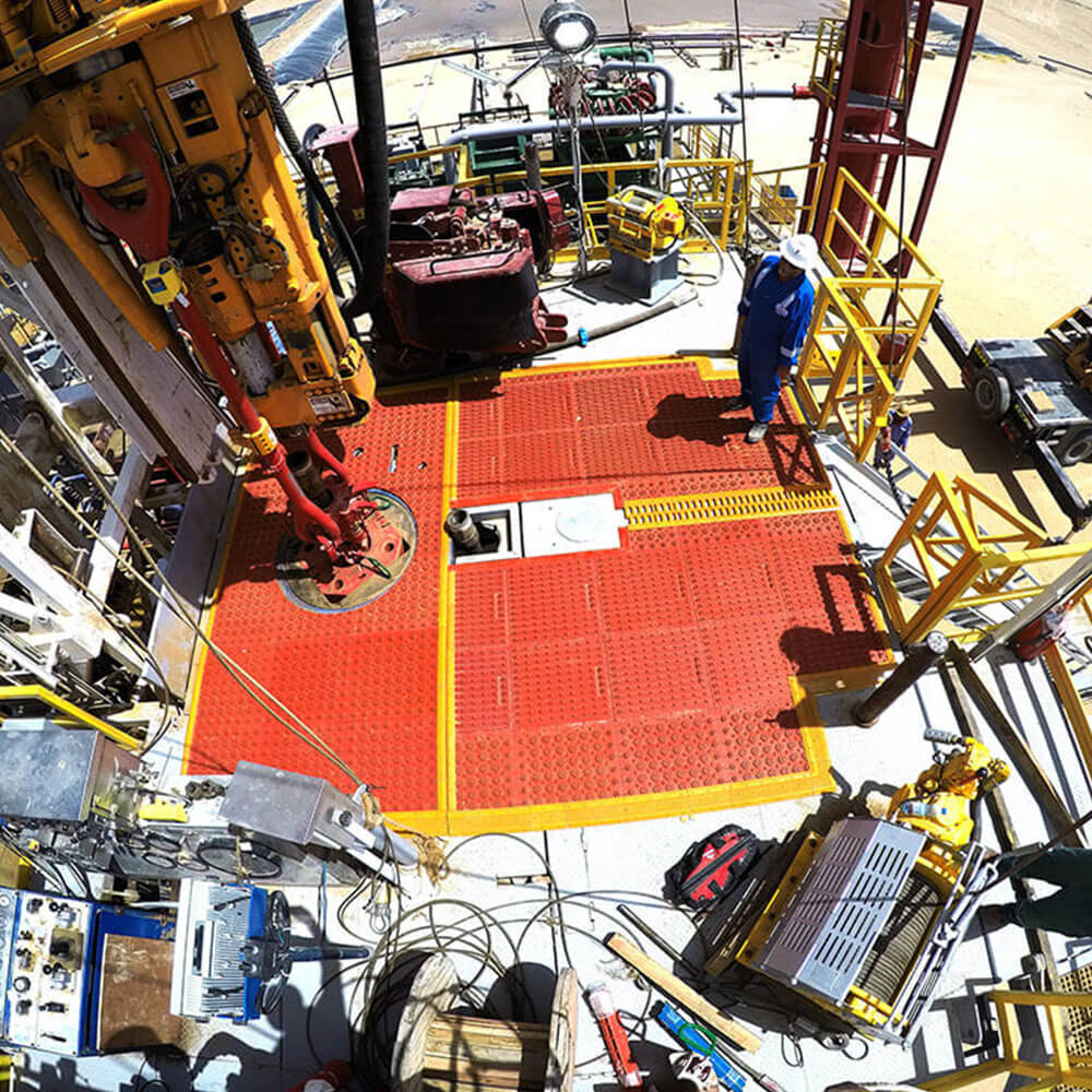 Katch Kan containment and matting system installed on a rig floor